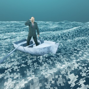 Man floating on puzzle piece sea